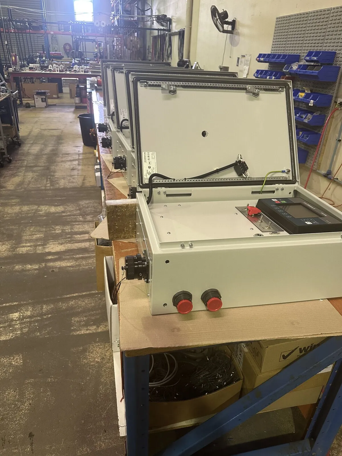 Row of completed industrial control panels ready for dispatch